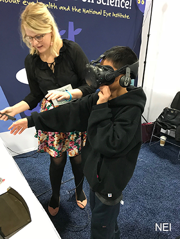 Boy using VR headset while a woman looks on